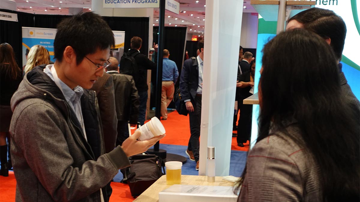 An NYSCC conference attendee looks at a sample of Applechem product.